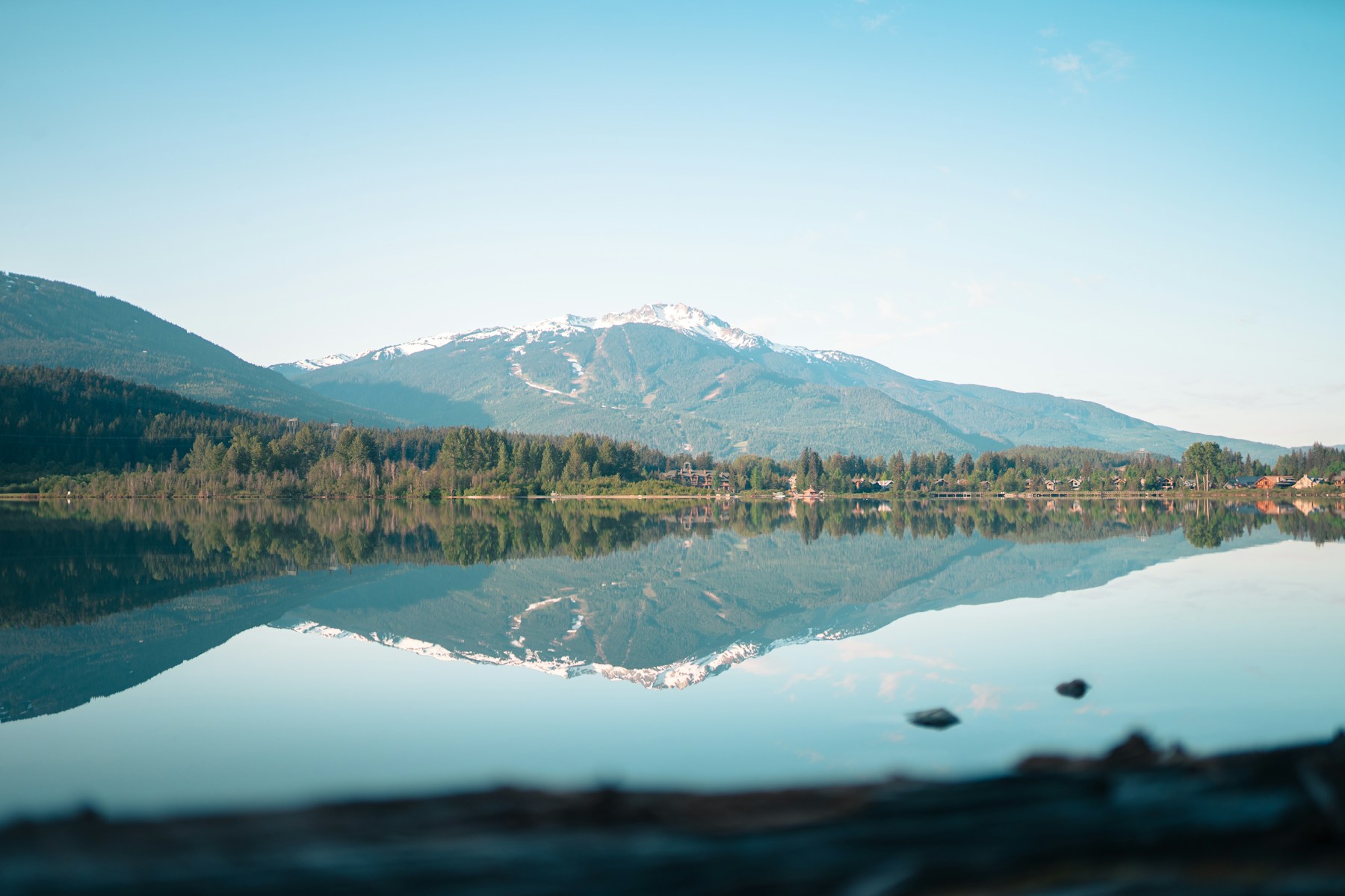 Mountain and forest reflected in a still lake in Whistler